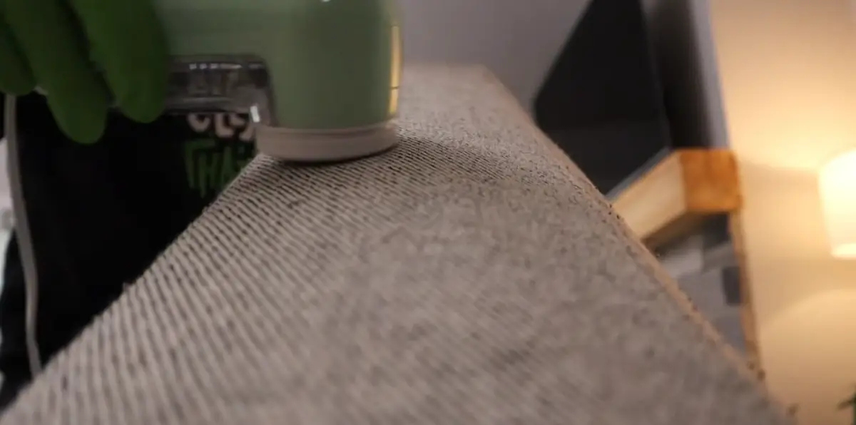 Close-up of fabric extraction tool cleaning upholstery texture